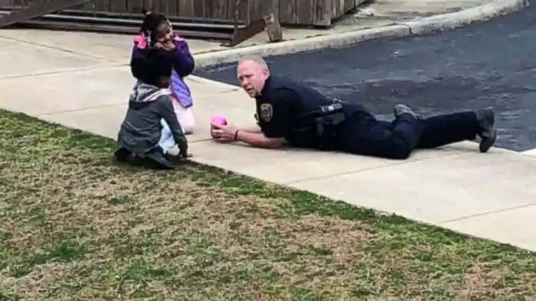 Après s'être assuré que les filles allaient bien, l'officier s'est assis par terre avec elles et a joué à la poupée